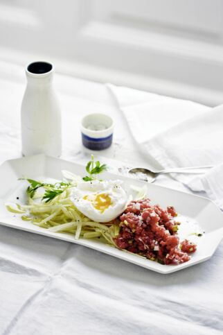 Rindertatar mit pochiertem Ei auf zitronigem Krautsalat